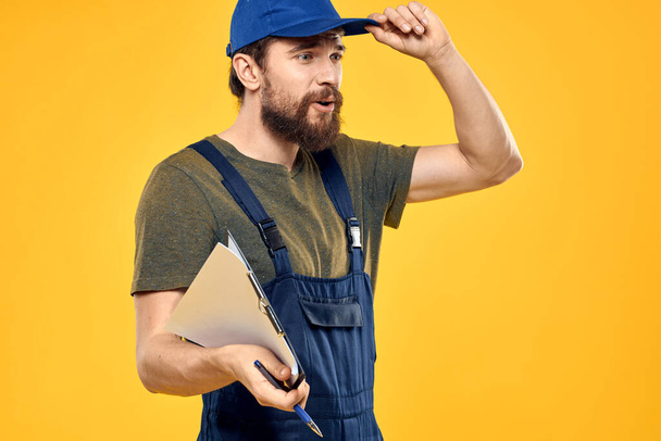 Man in working form documents transportation delivery service yellow background - Photo, Image