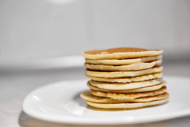 A stack of pancakes is on a white plate, Pancakes on a white plate top view, Pancakes on a white plate, - Fotografie, Obrázek