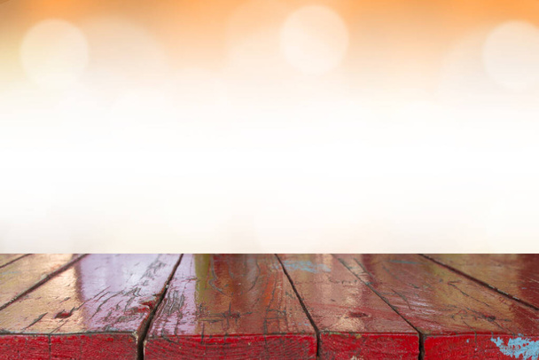 Empty desk with blurred light orange gradient bokeh abstract background. - Photo, Image