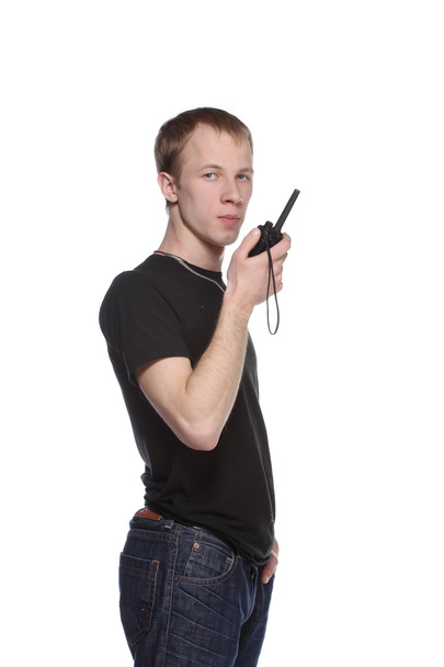Young security officer talking through his walkie talkie. - Foto, Imagen