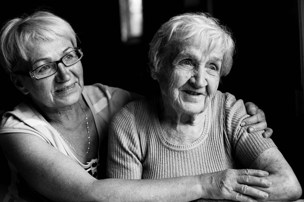 Una anciana con su hija adulta. Fotografía en blanco y negro. - Foto, Imagen