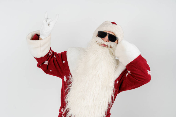 Christmas and New Years concept. Santa Claus shows a gesture by raising up two fingers. Isolated background. - Foto, Imagen