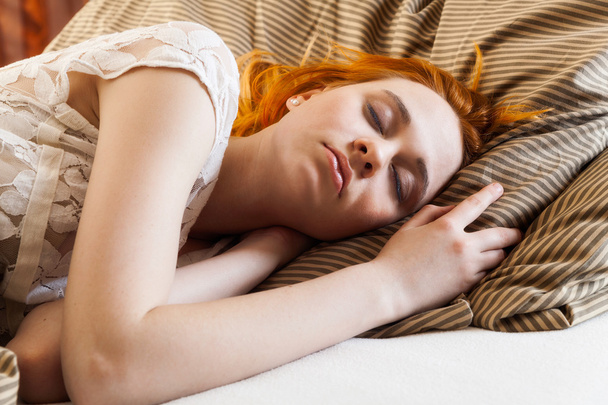 Young woman sleeping in bed - Fotografie, Obrázek