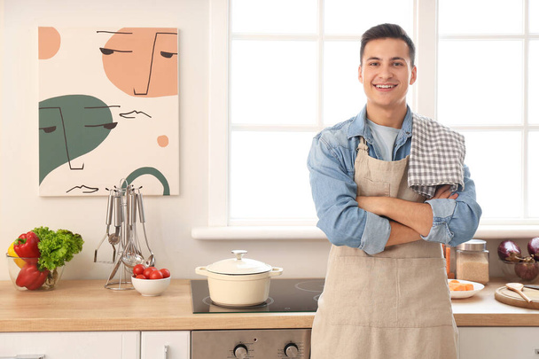 Portrait of handsome young man in kitchen - Fotografie, Obrázek