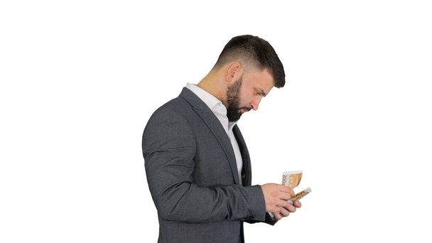 Happy and satisfied businessman counting euros on white backgrou - Foto, imagen
