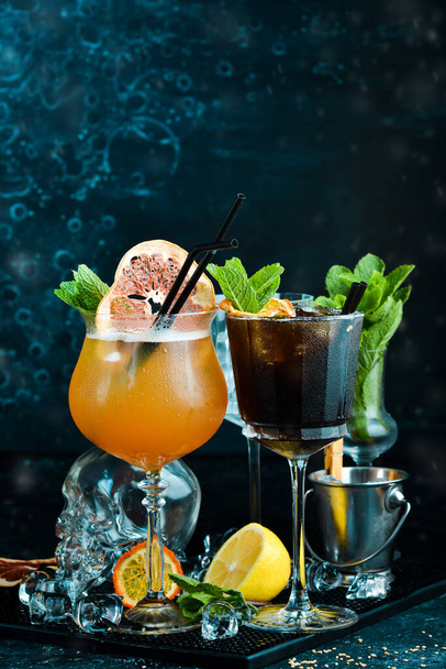 Set of colored alcoholic cocktails on a black stone background. Menu bar. Alcohol. - Fotó, kép