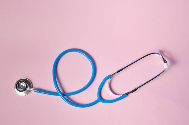 blue stethoscope on pink background. For check heart or health check up concept - Fotó, kép