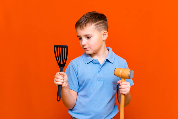 professional youn boy kid chef on orange background.housewifes Green grocery concept. - Photo, Image