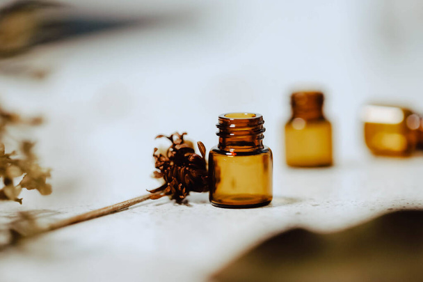 A closeup shot of small iron jars and dried flowers for herbal medicine - Foto, immagini