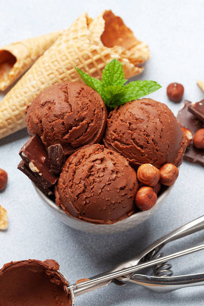 Chocolate with nuts ice cream scoopes and waffle cones - Фото, изображение