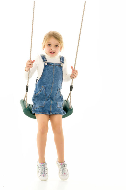 Full Length Shot of Cute Happy Girl Sitting on Rope Swing - Photo, Image
