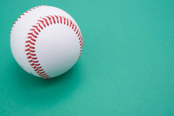 A baseball ball isolated on turquoise background - 写真・画像