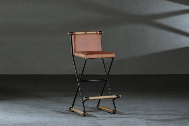 A closeup of a brown armless foldable chair - Foto, Bild