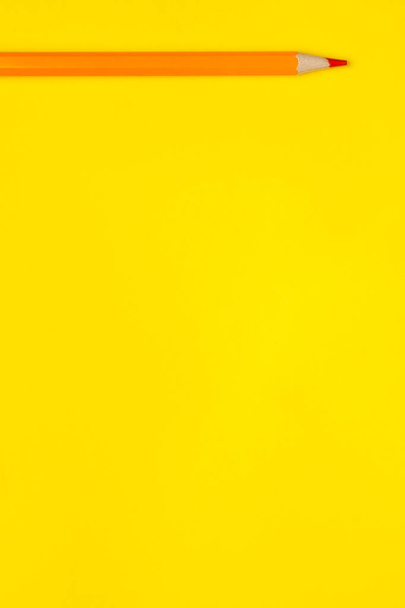 horizontal orange sharp wooden pencil on a bright yellow background, isolated, copy space, mock up - Φωτογραφία, εικόνα