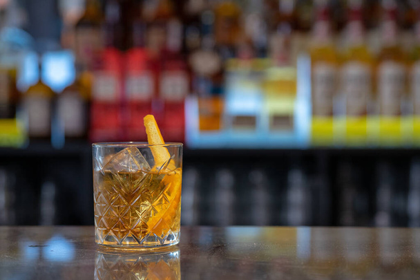 A closeup shot of original alcoholic cocktails with lemon garnish in a bar table - Fotografie, Obrázek