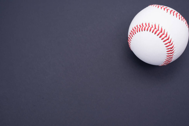 A baseball ball isolated on blue background - 写真・画像