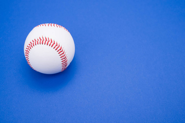 A baseball ball isolated on blue background - Foto, Imagen