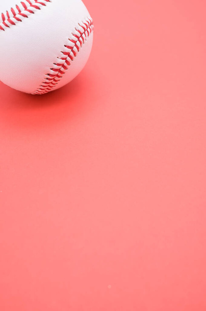 A vertical shot of a baseball ball isolated on pink background - Valokuva, kuva