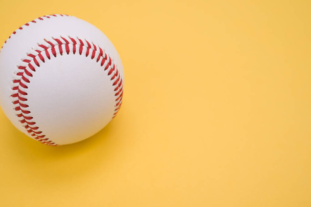 A baseball ball isolated on yellow background - 写真・画像