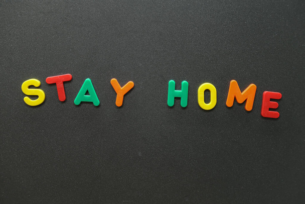 The inscription STAY HOME on a dark background - the concept for staying safe during pandemic - 写真・画像