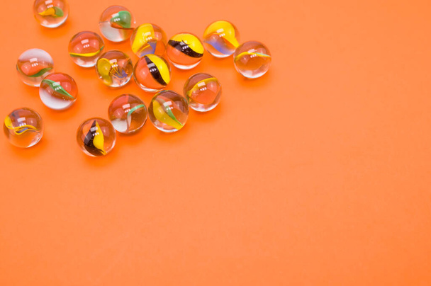 The transparent glass balls on an orange background - Foto, Imagem