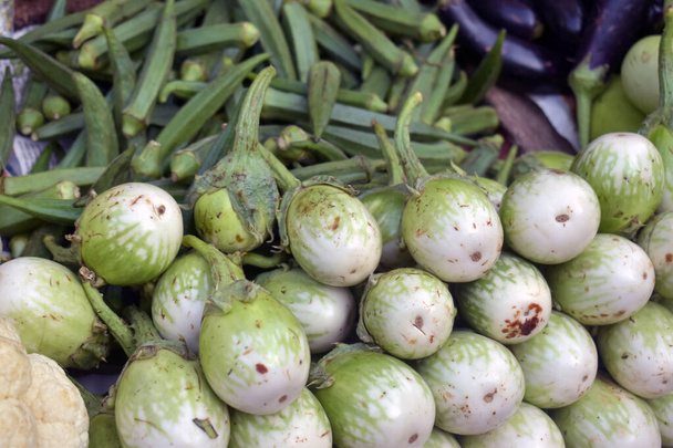 A closeup shot of green eggplants in a market place - 写真・画像