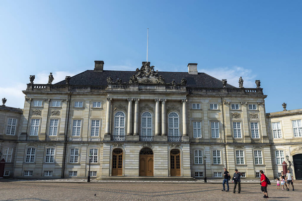 Copenhagen, Denmark - August 27, 2019: Facade of the Christian VII Palace (Moltke Palace) with people around in Amalienborg, Copenhagen, Denmark - Fotó, kép