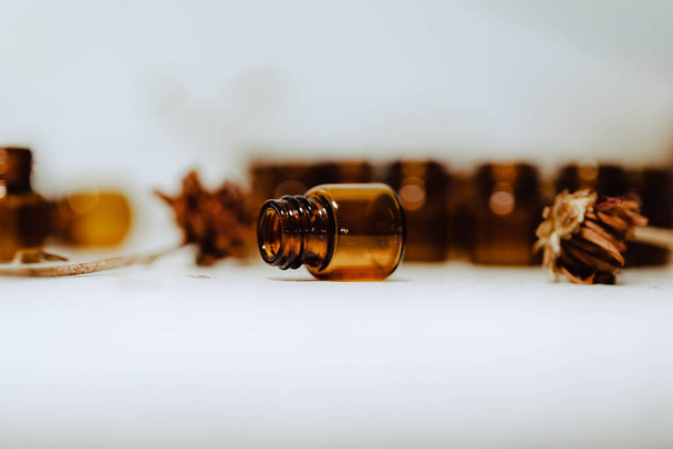 A closeup shot of small iron jars and dried flowers for herbal medicine - Φωτογραφία, εικόνα
