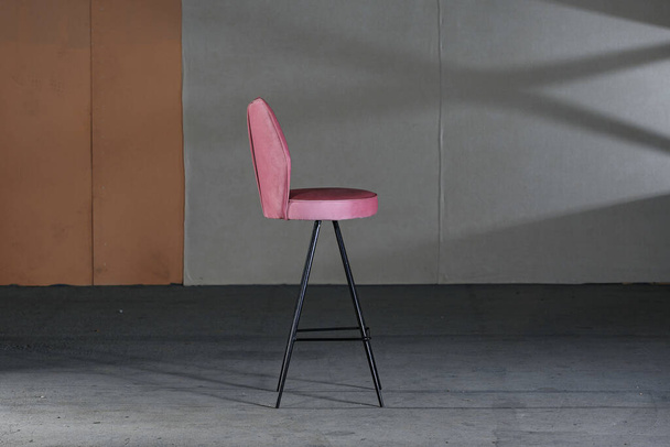 A high modern chair with long legs and purple soft upholstery - Valokuva, kuva
