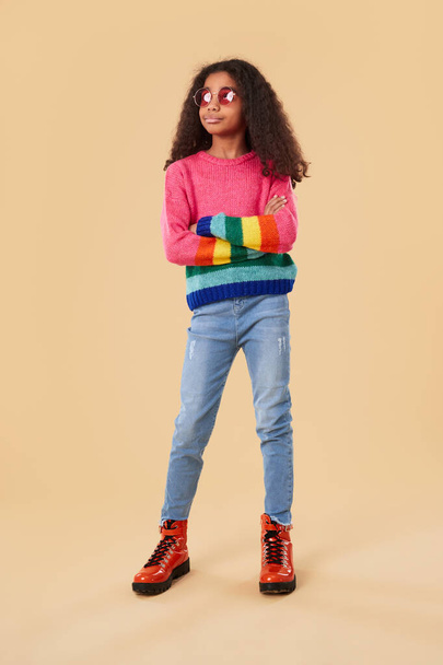 Confident black girl in rainbow sweater - Фото, изображение