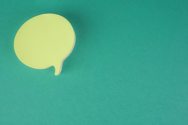 A closeup shot of a chat icon isolated on green background - Photo, image