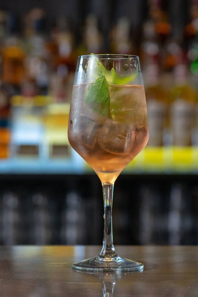 A closeup shot of a glass of refreshing cocktail in a bar - Photo, Image