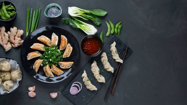 Asian dumplings set with variety of sauces and vegatables. Top view, Copy space - Фото, изображение