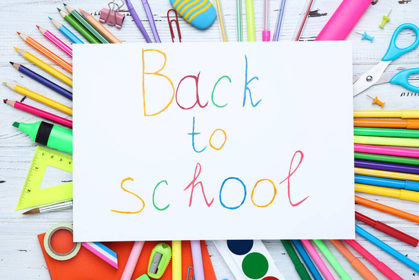 Text Back to School with stationery on white wooden table - Foto, Imagen