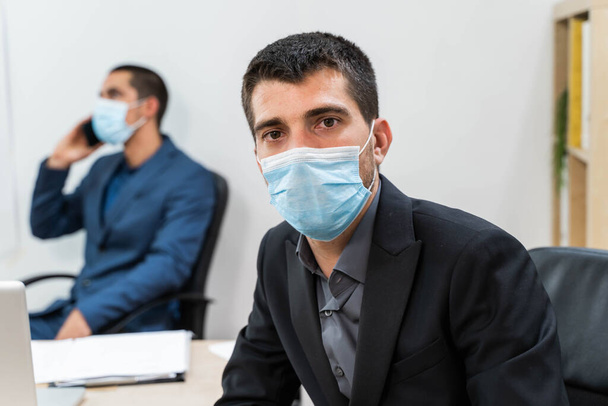 Businessman portrait. Business workers with face mask back at work in office after lockdown. Safety workplace. Office background. Success concept. New normality.  - Photo, image