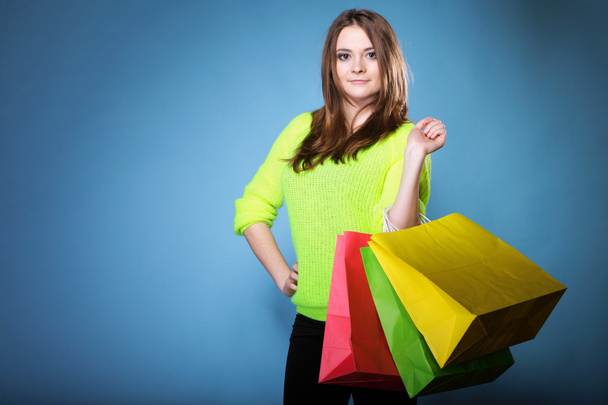 young woman with paper multi coloured shopping bag - Foto, immagini