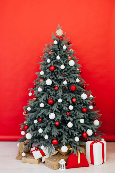 Christmas tree with gifts interior decor red background New Year winter holiday - Foto, immagini