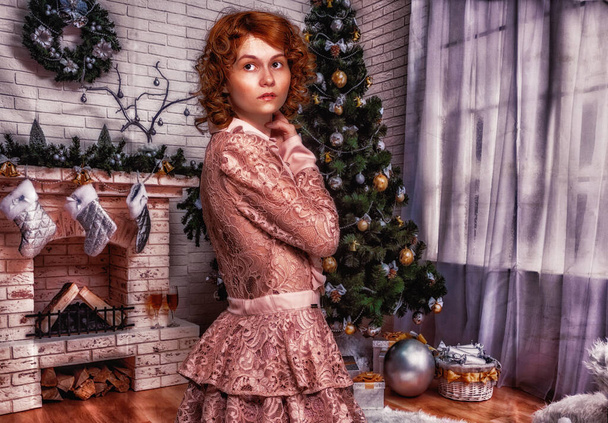Young woman in a Christmassy decorated room. - Photo, image