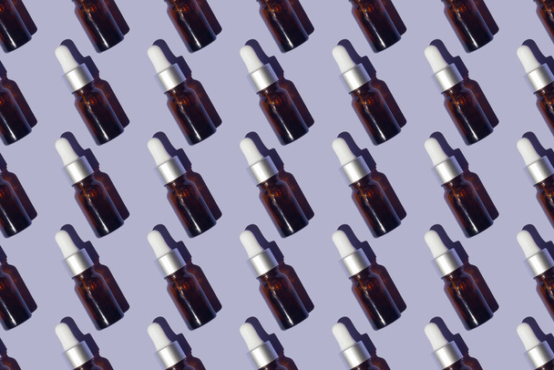 Seamless pattern of serums with collagen on purple background - Zdjęcie, obraz