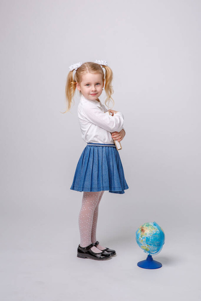 little girl in school uniform on white background - Foto, afbeelding