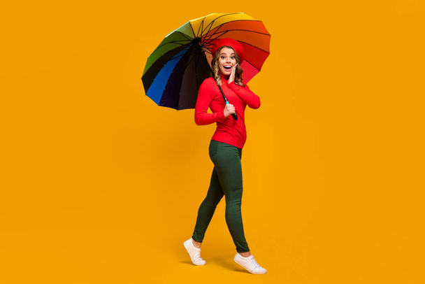 Full length body size view of nice attractive lovely amazed cheerful cheery wavy-haired girl holding in hand parasol going having fun isolated on bright vivid shine vibrant yellow color background - Photo, image