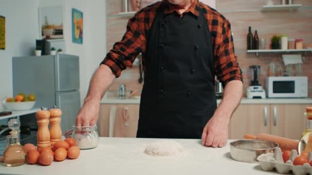 Bakery man sifting flour, preparing bread dough - Footage, Video