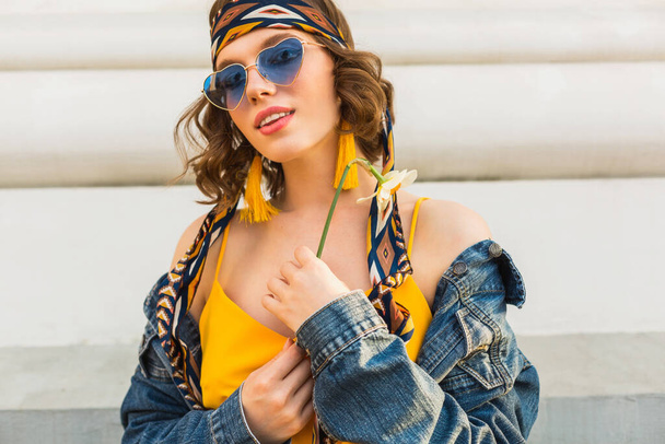 beautiful sexy stylish woman in yellow stylish dress wearing denim jacket, trendy outfit, spring summer fashion trend, sunny, blue sunglasses, street fashion, hipster style, fashionable accessories - Fotografie, Obrázek