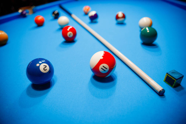 The game of American billiards. Multi-colored billiard balls on gaming table. - Фото, изображение