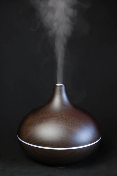 Aroma oil diffuser against black background - Photo, Image