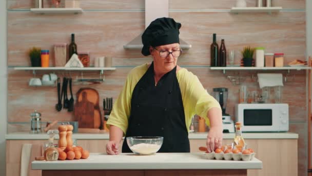 Mujer panadero crujiendo huevos - Imágenes, Vídeo