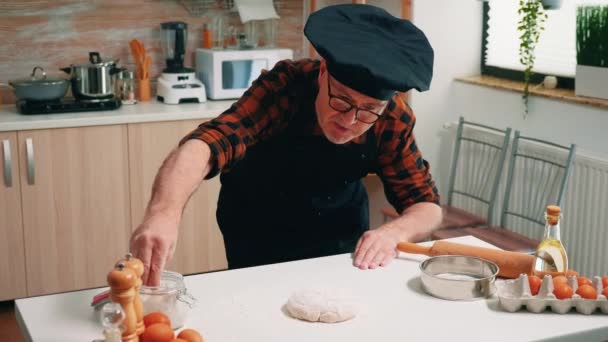 Sieving flour on a wooden chopping board to make dough - Footage, Video