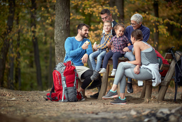 Happy family having a picnic together in the woods - Фото, зображення