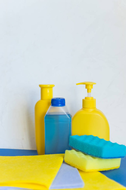 Professional cleaning equipment on white background. Cleaning tools concept. composition with Plastic detergent bottles. House cleaning products.Detergents, chemical bottles, cleaning sponges - Photo, image