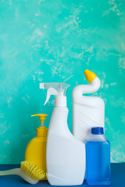 Professional cleaning equipment on blue background overview. Cleaning tools concept. composition with Plastic detergent bottles. House cleaning products.Detergents, chemical bottles, cleaning sponges - Fotó, kép